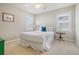 Cozy bedroom with a full-size bed and two windows at 209 Charleston Blvd, Isle of Palms, SC 29451