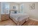 Bright bedroom with a double bed, dresser, and hardwood floors at 209 Charleston Blvd, Isle of Palms, SC 29451