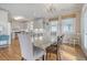 Bright dining room with hardwood floors and chandelier, adjacent to kitchen at 209 Charleston Blvd, Isle of Palms, SC 29451