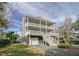 Two-story house with gray siding, double front porch, and stairs leading to the entrance at 209 Charleston Blvd, Isle of Palms, SC 29451
