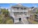 Two-story home with gray siding, multiple decks, and a detached garage at 209 Charleston Blvd, Isle of Palms, SC 29451