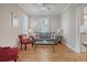 Cozy living room with gray sofa and red accent chairs at 209 Charleston Blvd, Isle of Palms, SC 29451