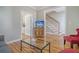 Living room features hardwood floors, glass coffee table, and staircase at 209 Charleston Blvd, Isle of Palms, SC 29451