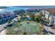 Aerial view showing tennis courts and waterfront community at 25 Mariners Cay Dr, Folly Beach, SC 29439