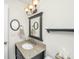 Bathroom with granite countertop, dark vanity, and framed mirror at 25 Mariners Cay Dr, Folly Beach, SC 29439