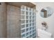 Bathroom with glass block shower, tile surround, and a white toilet at 25 Mariners Cay Dr, Folly Beach, SC 29439