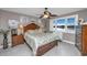 Main bedroom with a large bed, water views and ceiling fan at 25 Mariners Cay Dr, Folly Beach, SC 29439