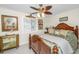 Bedroom with a large wooden bed, decorative pillows, and ceiling fan at 25 Mariners Cay Dr, Folly Beach, SC 29439