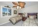 Bedroom with two twin beds, ceiling fan, and neutral decor at 25 Mariners Cay Dr, Folly Beach, SC 29439