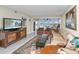 Spacious living room boasting a sectional sofa, armchairs, and a large TV at 25 Mariners Cay Dr, Folly Beach, SC 29439