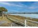 Waterfront view with calm water, bridge, and palm trees at 25 Mariners Cay Dr, Folly Beach, SC 29439