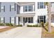 Cozy rocking chairs on a front porch with white columns and landscaping at 272 Spencer Cir, Summerville, SC 29485