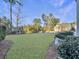 Spacious backyard with grassy area, partially visible neighboring houses, and mature trees at 3002 Cross Vine Ln, Summerville, SC 29483