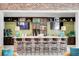 Community bar with brick wall, dark wood cabinets and seating at 3002 Cross Vine Ln, Summerville, SC 29483