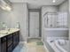 Bathroom with double vanity, soaking tub, and walk-in shower at 3002 Cross Vine Ln, Summerville, SC 29483