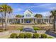 Community center with large windows, a metal roof, and landscaping at 3002 Cross Vine Ln, Summerville, SC 29483
