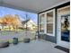 Covered porch with seating area, offering a view of the street and neighborhood at 3002 Cross Vine Ln, Summerville, SC 29483