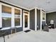 Covered porch with gray siding, white trim, and comfortable wicker furniture at 3002 Cross Vine Ln, Summerville, SC 29483