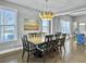 Bright dining room with large table, hardwood floors, and stylish light fixture at 3002 Cross Vine Ln, Summerville, SC 29483