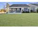 Back exterior of house showcasing a screened porch and a neatly landscaped lawn at 3002 Cross Vine Ln, Summerville, SC 29483
