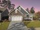 Two-story house with stone and gray siding, white garage door, and a front porch at 3002 Cross Vine Ln, Summerville, SC 29483
