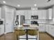 Modern kitchen featuring white cabinets, granite countertops, and stainless steel appliances at 3002 Cross Vine Ln, Summerville, SC 29483