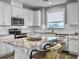 Kitchen island with granite countertop and seating for two at 3002 Cross Vine Ln, Summerville, SC 29483