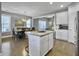 Open concept kitchen and dining area with hardwood floors and island at 3002 Cross Vine Ln, Summerville, SC 29483