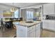 Open concept kitchen and dining area with hardwood floors and island at 3002 Cross Vine Ln, Summerville, SC 29483