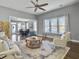 Open living room featuring hardwood floors, a neutral color palette and ample natural light at 3002 Cross Vine Ln, Summerville, SC 29483