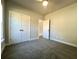 Spacious bedroom with gray carpeting, double doors, and access to a hallway at 3012 Harvey Ave, North Charleston, SC 29405