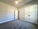Spacious bedroom with gray carpeting, double doors, and access to a hallway at 3012 Harvey Ave, North Charleston, SC 29405