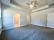 Main bedroom with gray carpet, ceiling fan, and access to the bathroom at 3012 Harvey Ave, North Charleston, SC 29405