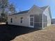 Rear view of house showcasing screened porch and yard at 3012 Harvey Ave, North Charleston, SC 29405