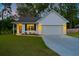 Charming white house with a gray roof, a two-car garage, and a well-manicured lawn at 3012 Harvey Ave, North Charleston, SC 29405