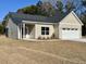 Beige house with gray roof, white garage door, and screened porch at 3012 Harvey Ave, North Charleston, SC 29405