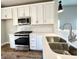 Modern kitchen with white cabinets, stainless steel appliances, and quartz countertops at 3012 Harvey Ave, North Charleston, SC 29405