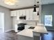 Modern kitchen with white cabinets, stainless steel appliances, and quartz countertops at 3012 Harvey Ave, North Charleston, SC 29405