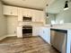 Modern kitchen with white cabinets, stainless steel appliances, and wood flooring at 3012 Harvey Ave, North Charleston, SC 29405