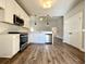 Open kitchen with white cabinets, stainless steel appliances, and hardwood floors at 3012 Harvey Ave, North Charleston, SC 29405