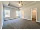 Bright main bedroom with gray carpet, a ceiling fan, and a walk-in closet at 3012 Harvey Ave, North Charleston, SC 29405