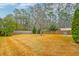 Fenced-in backyard with a large grassy area and trees at 3312 Middlesboro Ave, Summerville, SC 29485