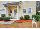 Inviting front porch with rocking chairs, and well-manicured landscaping at 3312 Middlesboro Ave, Summerville, SC 29485