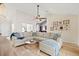 Open living room with a sectional sofa, hardwood floors, and a vaulted ceiling at 344 Slow Mill Dr, Goose Creek, SC 29445