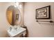Clean and simple powder room with an oval mirror and pedestal sink at 3687 Hilton Dr, Johns Island, SC 29455