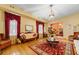 Living room with hardwood floors, antique furniture, and a red rug at 3687 Hilton Dr, Johns Island, SC 29455