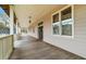 Long front porch with wooden floors and white railings at 3687 Hilton Dr, Johns Island, SC 29455