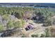 Aerial view showing house, barn, and surrounding trees at 369 Groomsville Rd, Moncks Corner, SC 29461