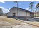 Tan and brown metal barn with large doors and lean-to at 369 Groomsville Rd, Moncks Corner, SC 29461