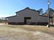 Tan and brown metal barn with large doors at 369 Groomsville Rd, Moncks Corner, SC 29461